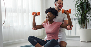 Young couple exercising together at home